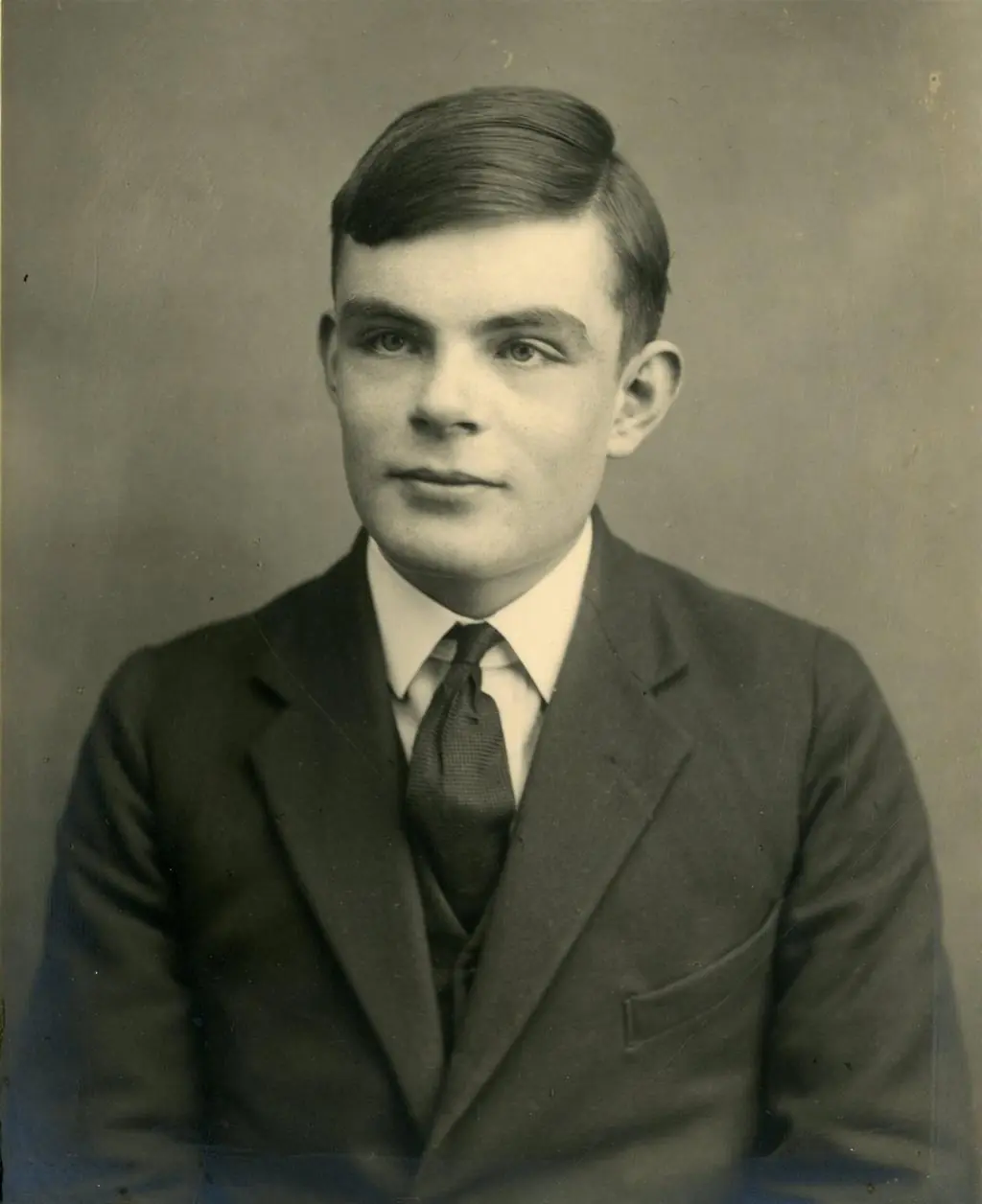 Alan Turing in his early passport-style photograph